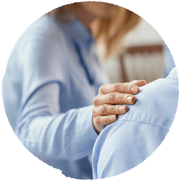 Person providing support by placing a hand on another person's shoulder